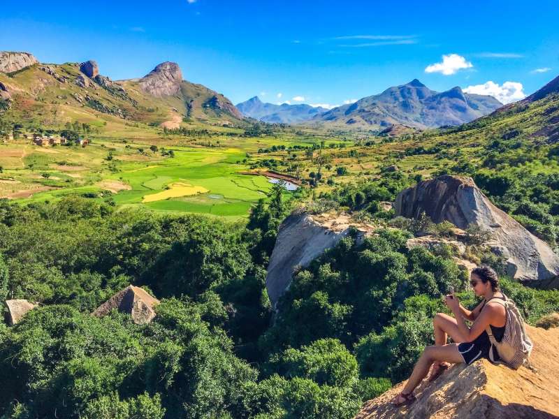 Student taking photo on mountain overlook
