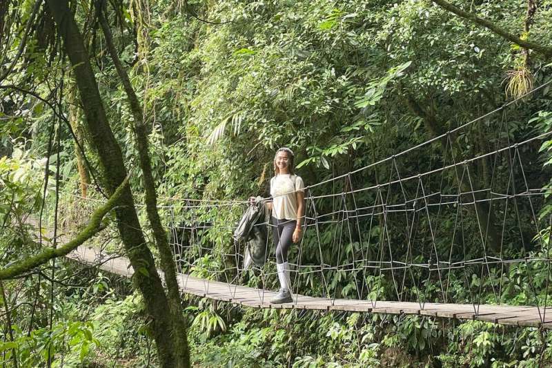 Student walking across bridge in Monteverde forest