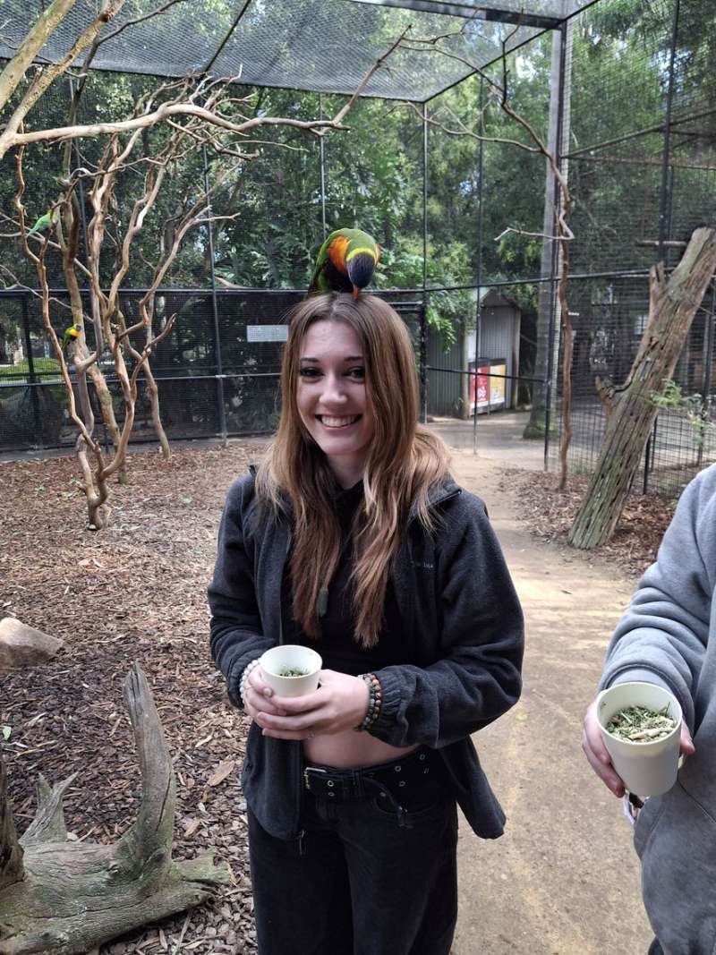 Student with parrot on her head