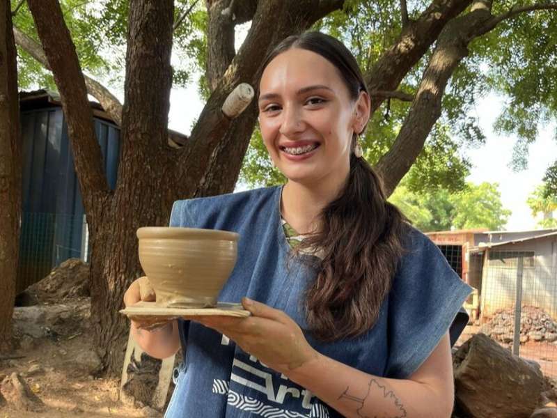 Student with pottery in Legon