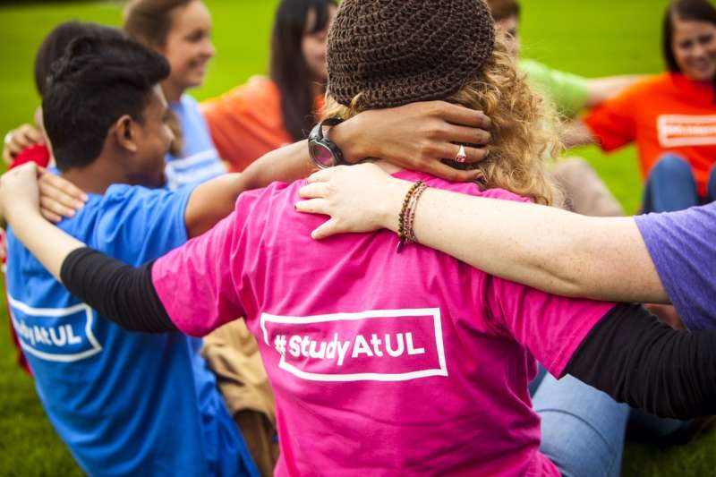 Students arms linked and T-Shirt reads  #study at UL 