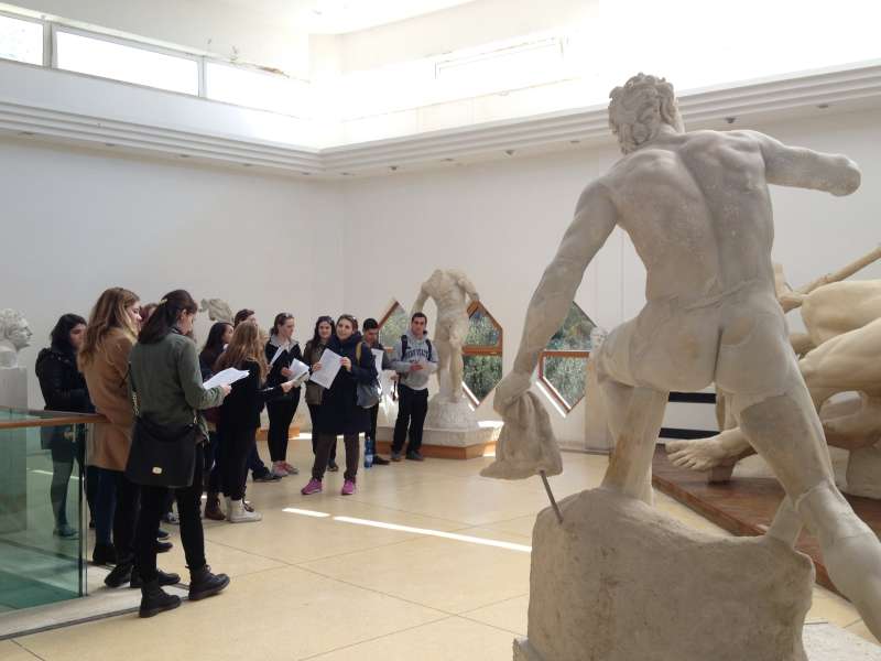 Students at a museum admiring art on a course trip.