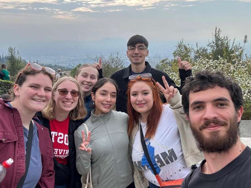 students atop a mountain overlooking Santiago