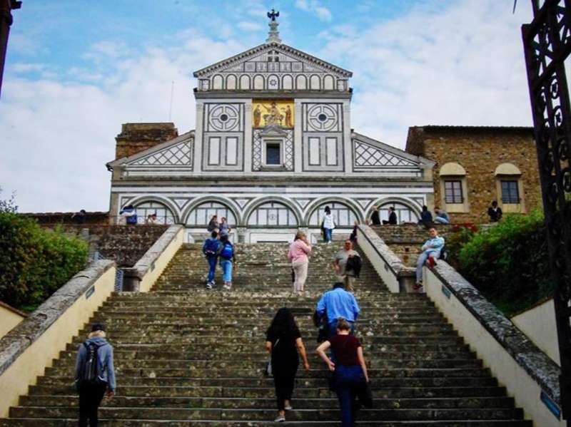 Students climbing stairs up to a church