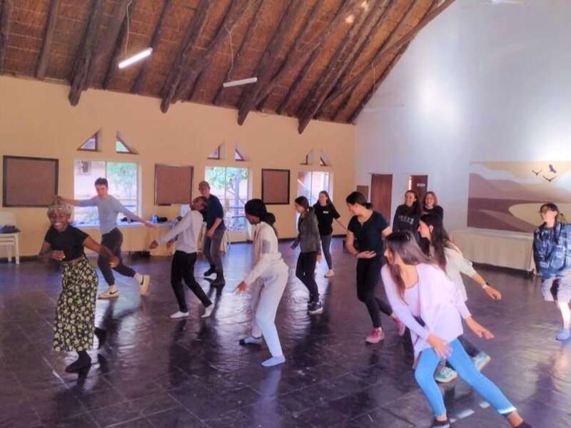 Students dancing with local instructor in Gaborone