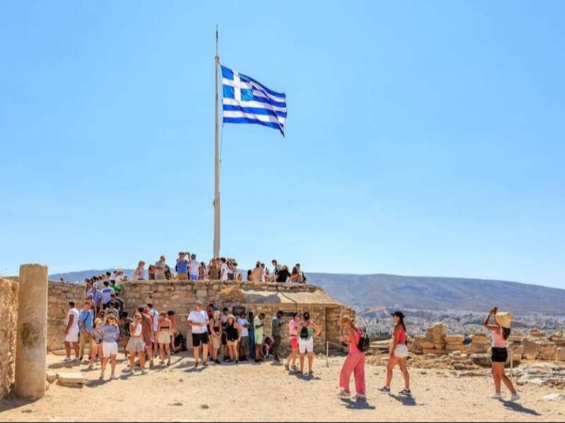 Students exploring in Athens with Greek flag