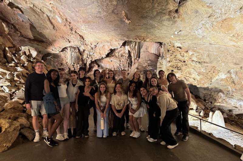 Students exploring Prague cave