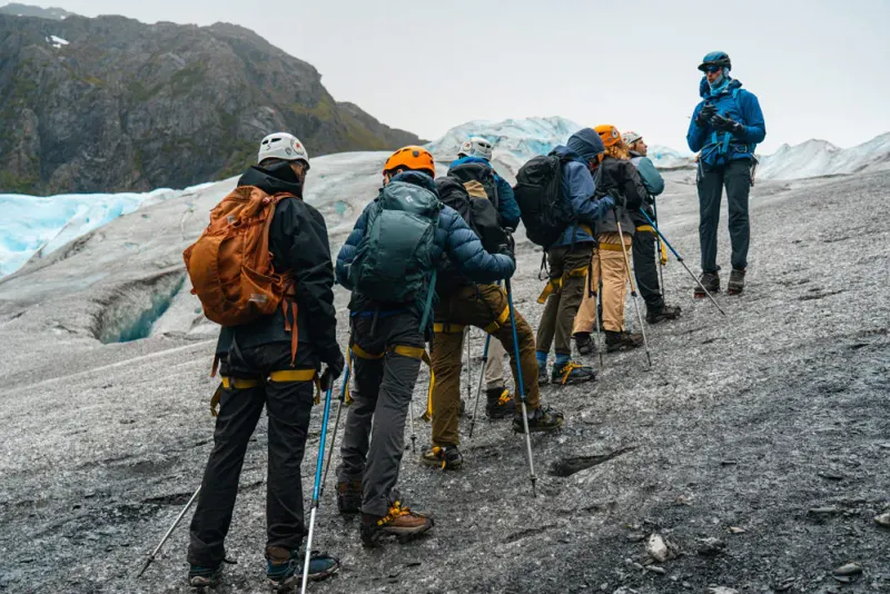Students hiking snowy mountain