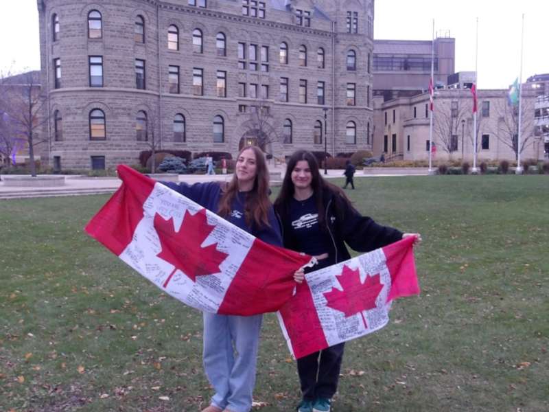 students holding Canadian flags 