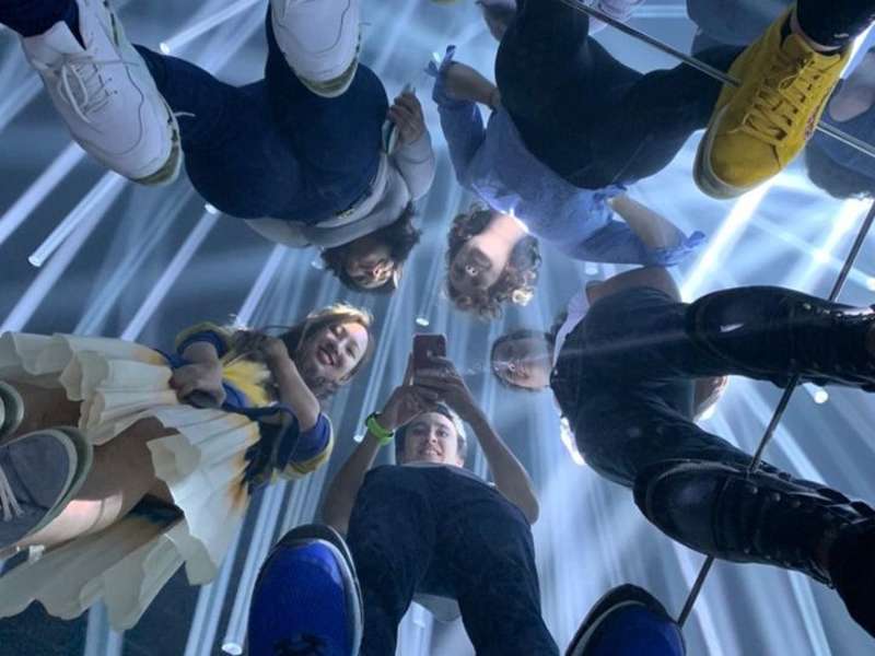 Students in a reflection at a museum