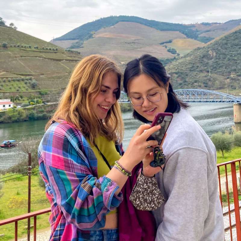 Students looking at a photo on an iPhone.
