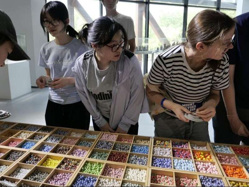 Students looking at beads in Shanghai