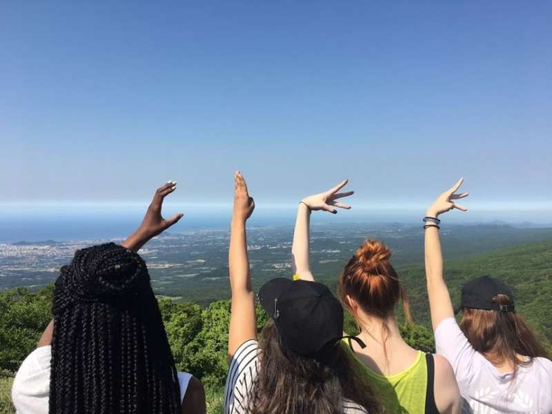 Students making CIEE with their hands in photo