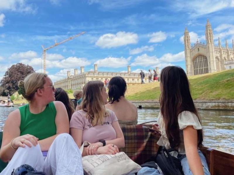 Students on boat in Cambridge looking at the beautiful architecture.