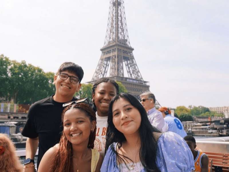 Students on boat in front of Eiffel Tower