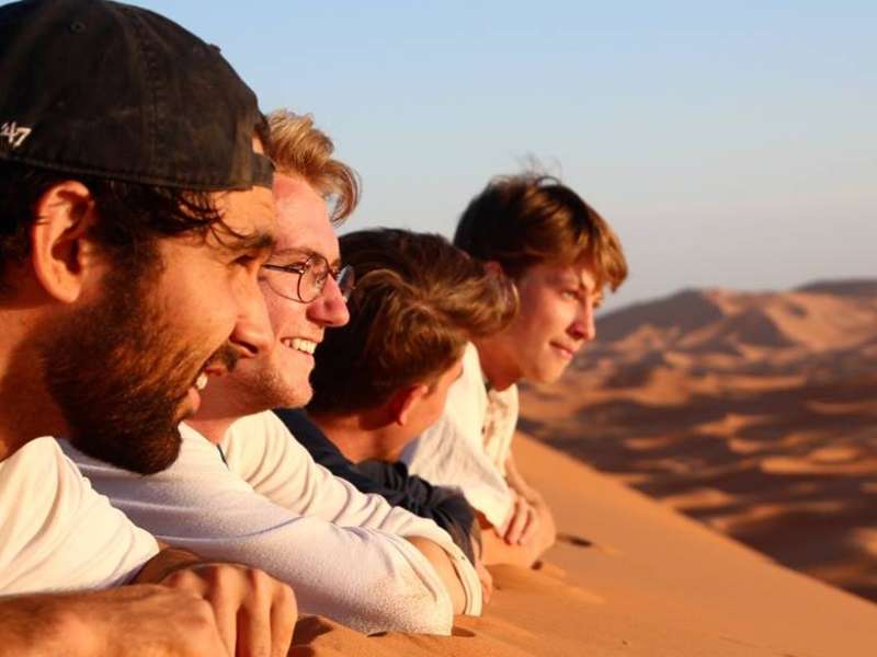 Students on sand dune in Jordan