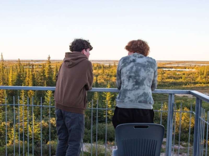 Students overlooking forrest in Canada