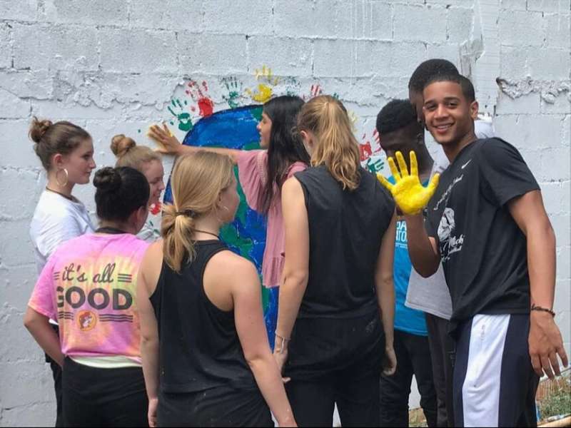Students painting a wall in Merida on program