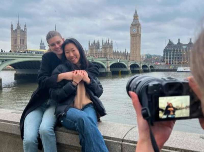 Students pose for a photo along the River Thames with Big Ben in the background.