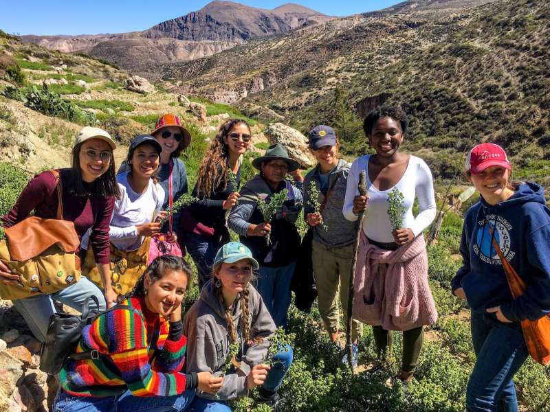 Students pose in front of mountain