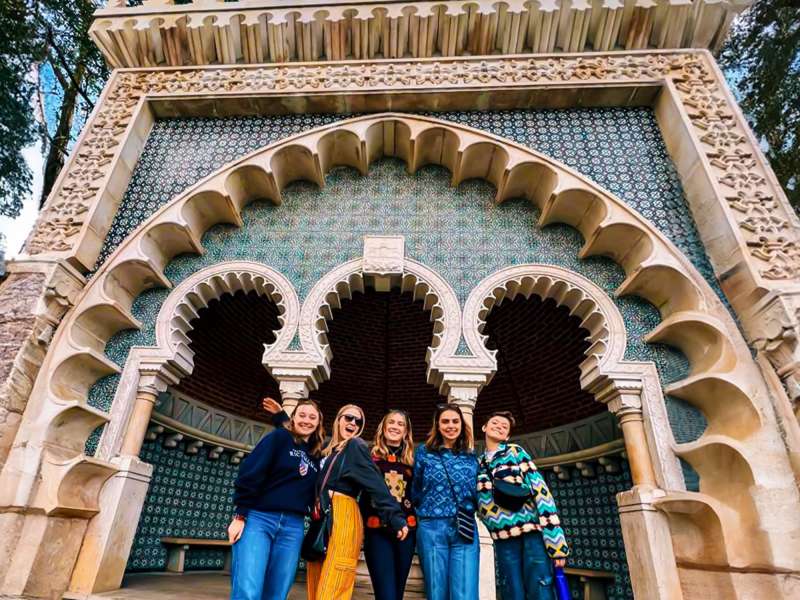 Students pose in front of tiling building