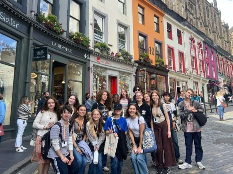 Students posing as group on Victoria Street in Edinburgh