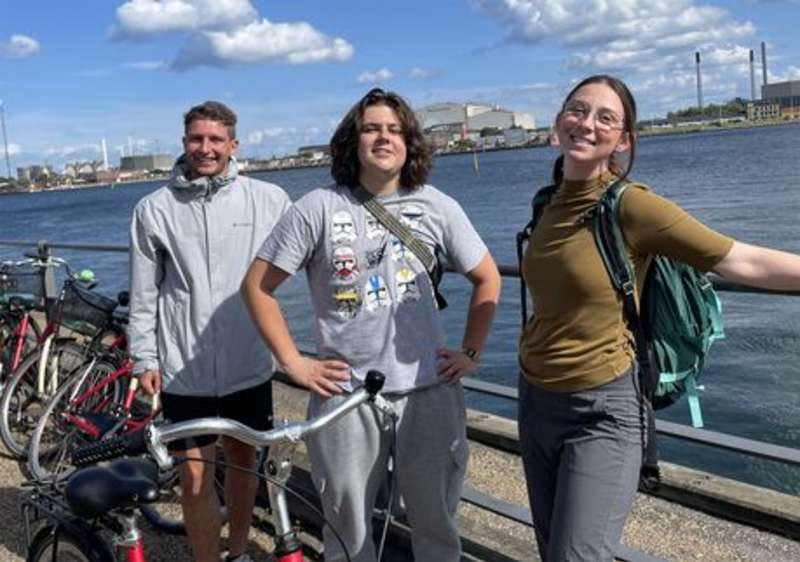 Students posing by bikes in Copenhagen