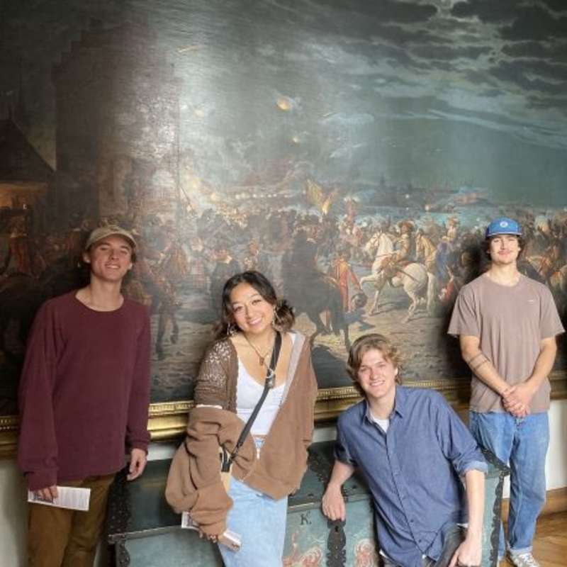 Students posing by painting in Copenhagen art museum