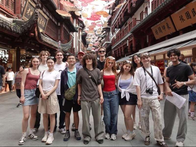 Students posing in alley in Shanghai