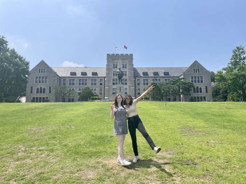 Students posing in front of building.