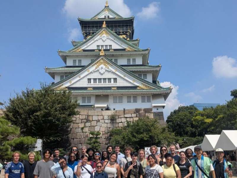Students posing in front of castle in Osaka