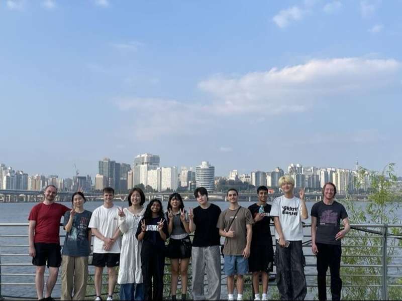 Students posing in front of river in Seoul