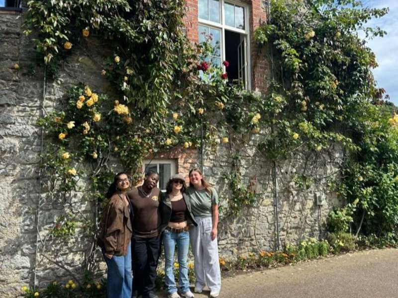 Students posing near ivy walled building in Dublin