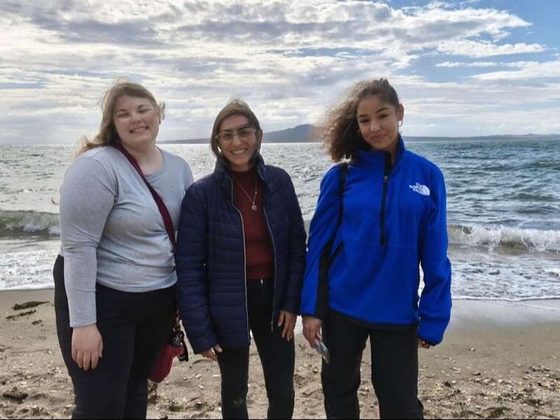 Students posing on beach in Auckland