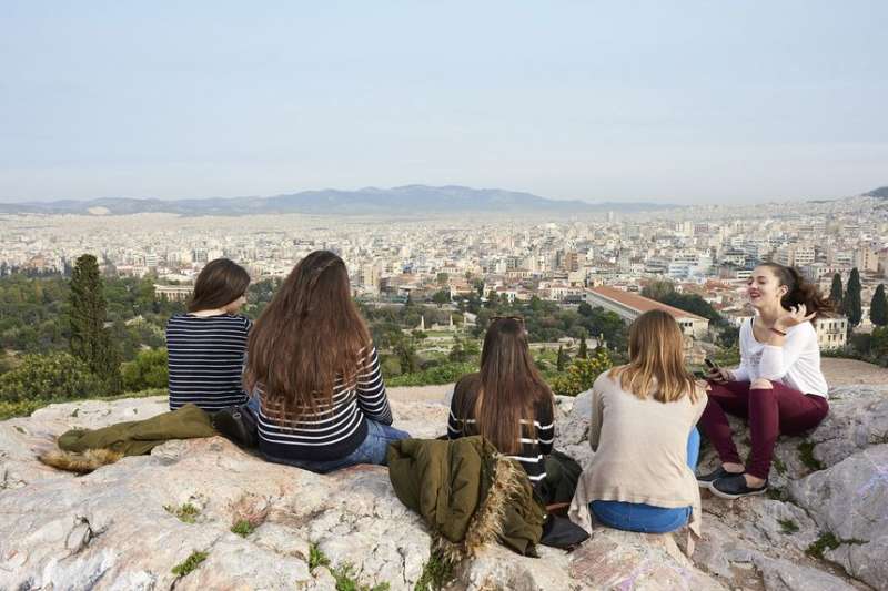 Students posing on cliff overlooking Athens