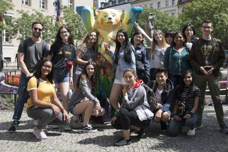 Students posing with bear statue in Berlin