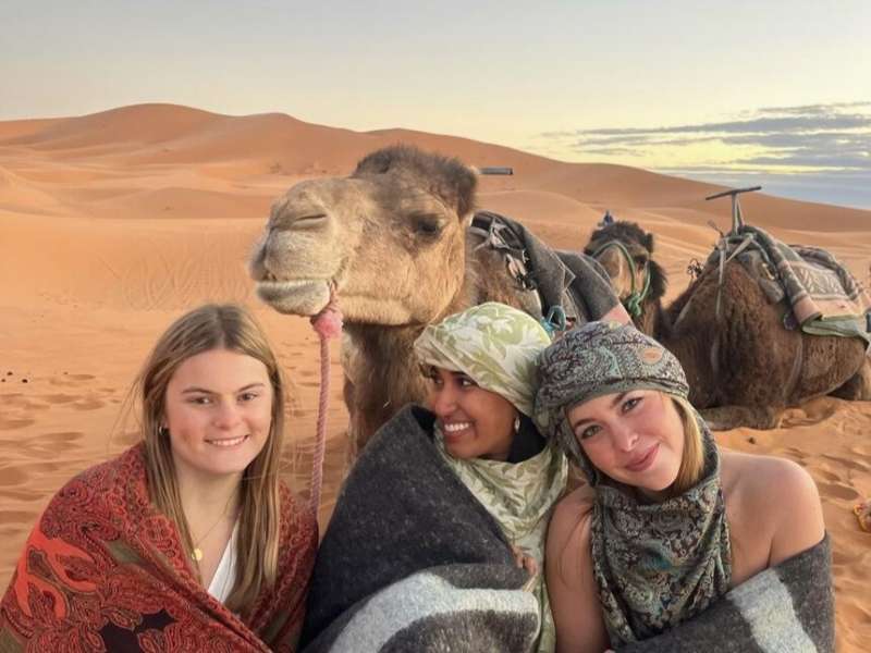 Students posing with camel in Morocco