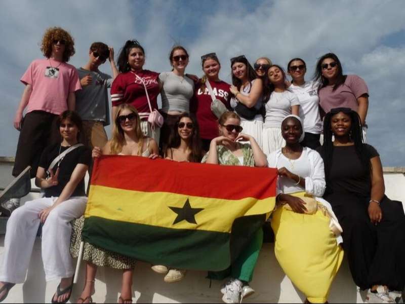 Students posing with flag in Legon