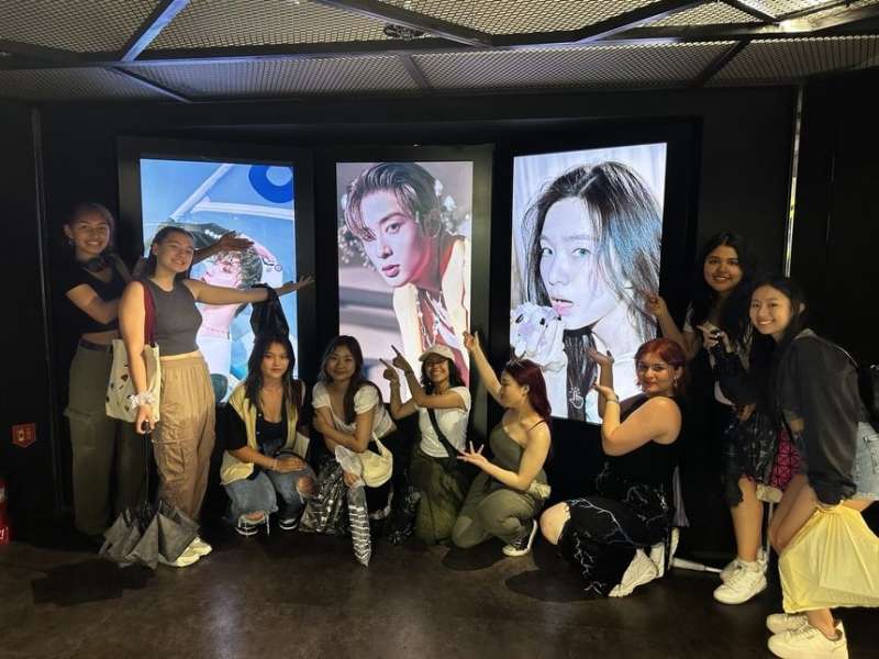Students posing with Korean pop idols
