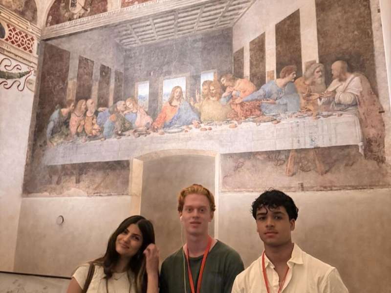 Students posing with The Last Supper painting in Italy