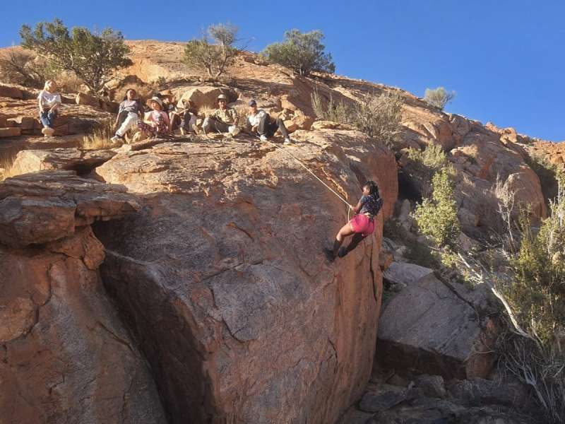 Students rock climbing on a school camping trip in Aus