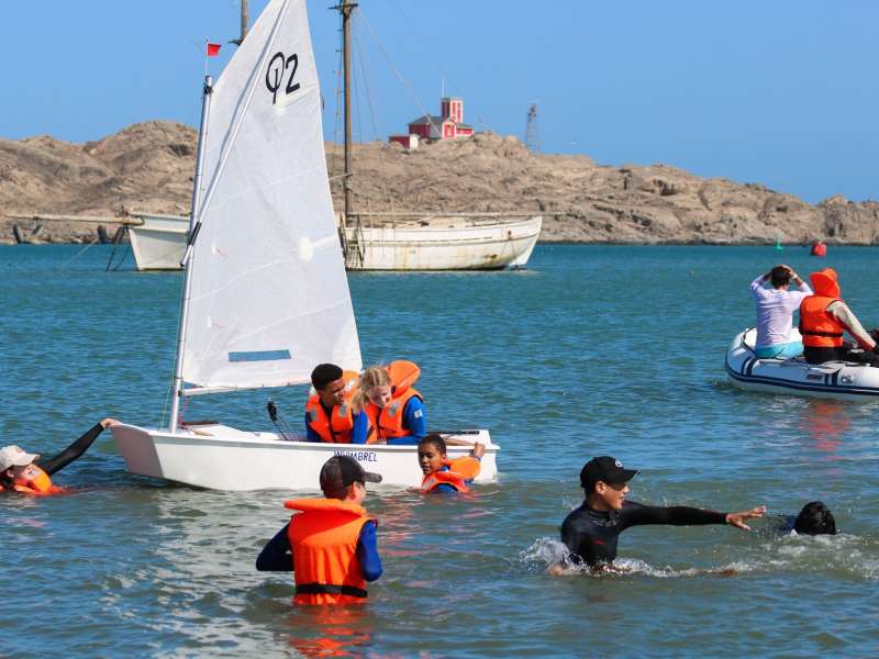 Students sailing and swimming in Lüderitz bay