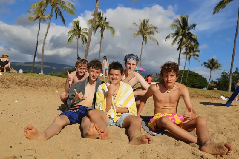 Students sit on the beach