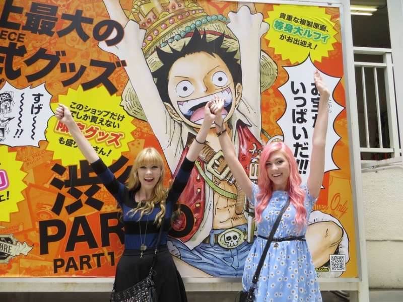 Students standing in front of one piece luffy poster