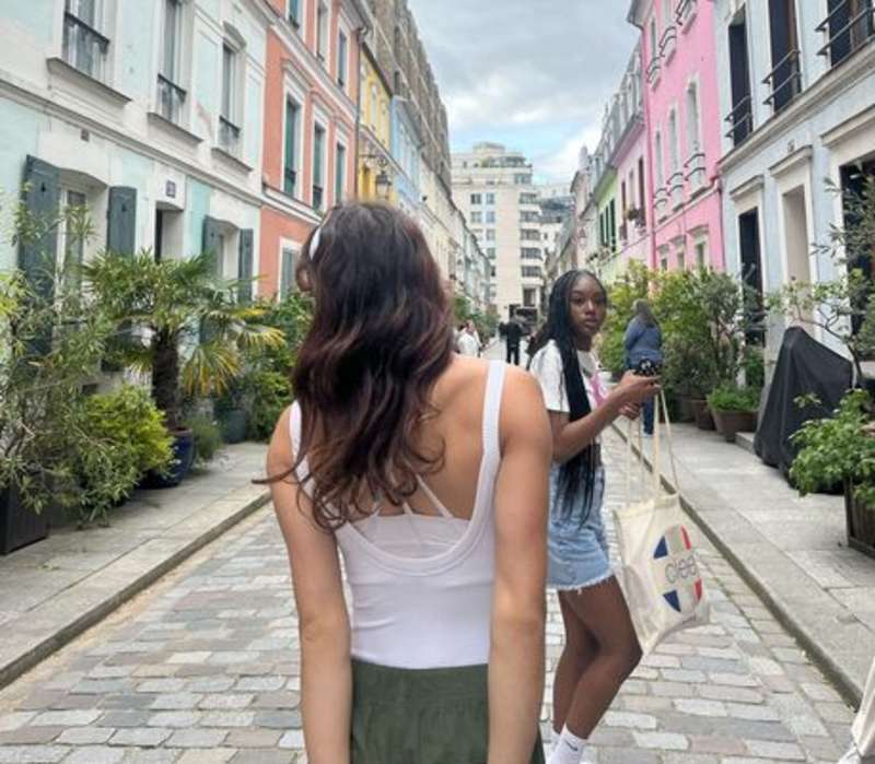 Students strolling down a colorful avenue in Paris