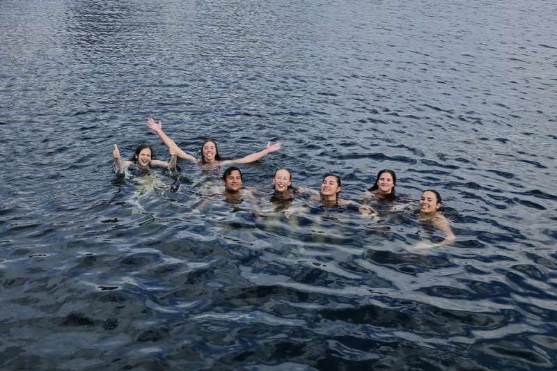 Students swimming in the water by Denmark coastline
