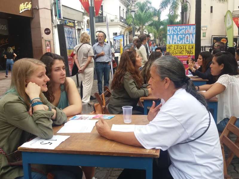 Students talking at a table as part of an event