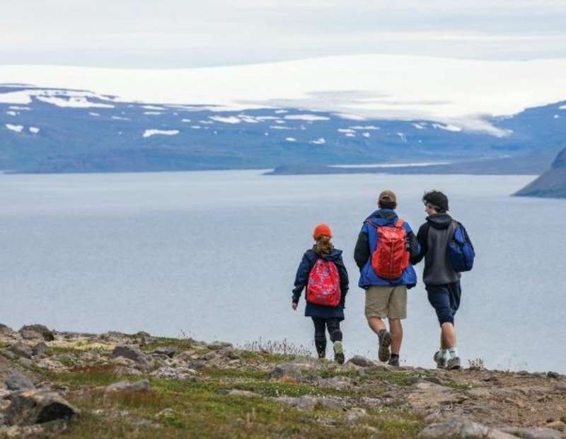 students hiking in iceland with bay in the background