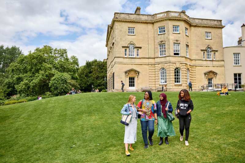 Students walking on the grass outside Royal Fort House