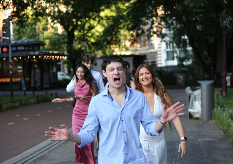 Students walking through Amsterdam on their way to the graduation photoshoot during their study abroad program.